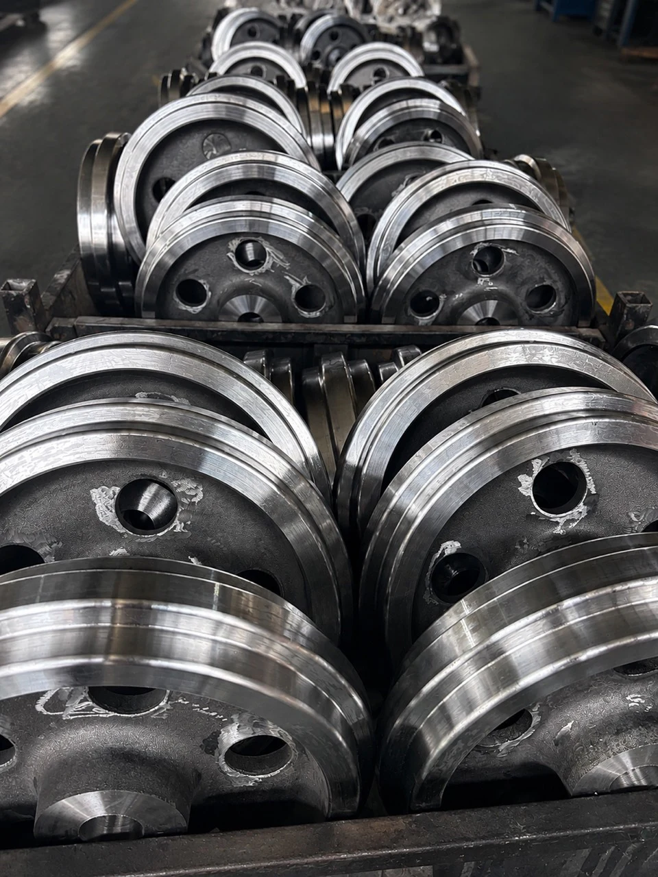 Batch of forged steel wheel components with machined outer surfaces